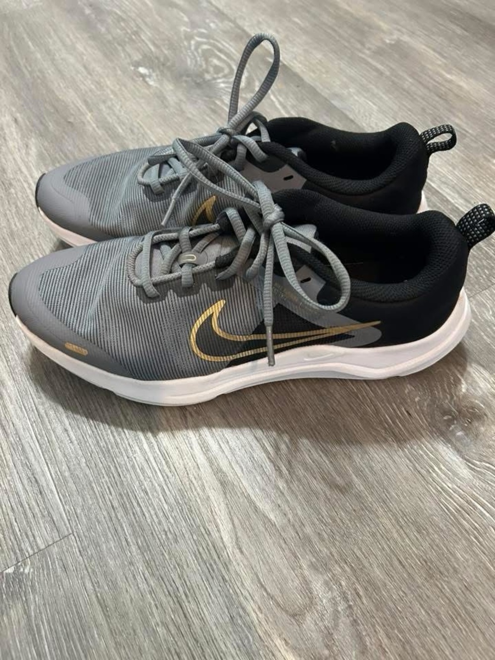Nike Youth Gray and Black Athletic Shoes with Gold Swoosh